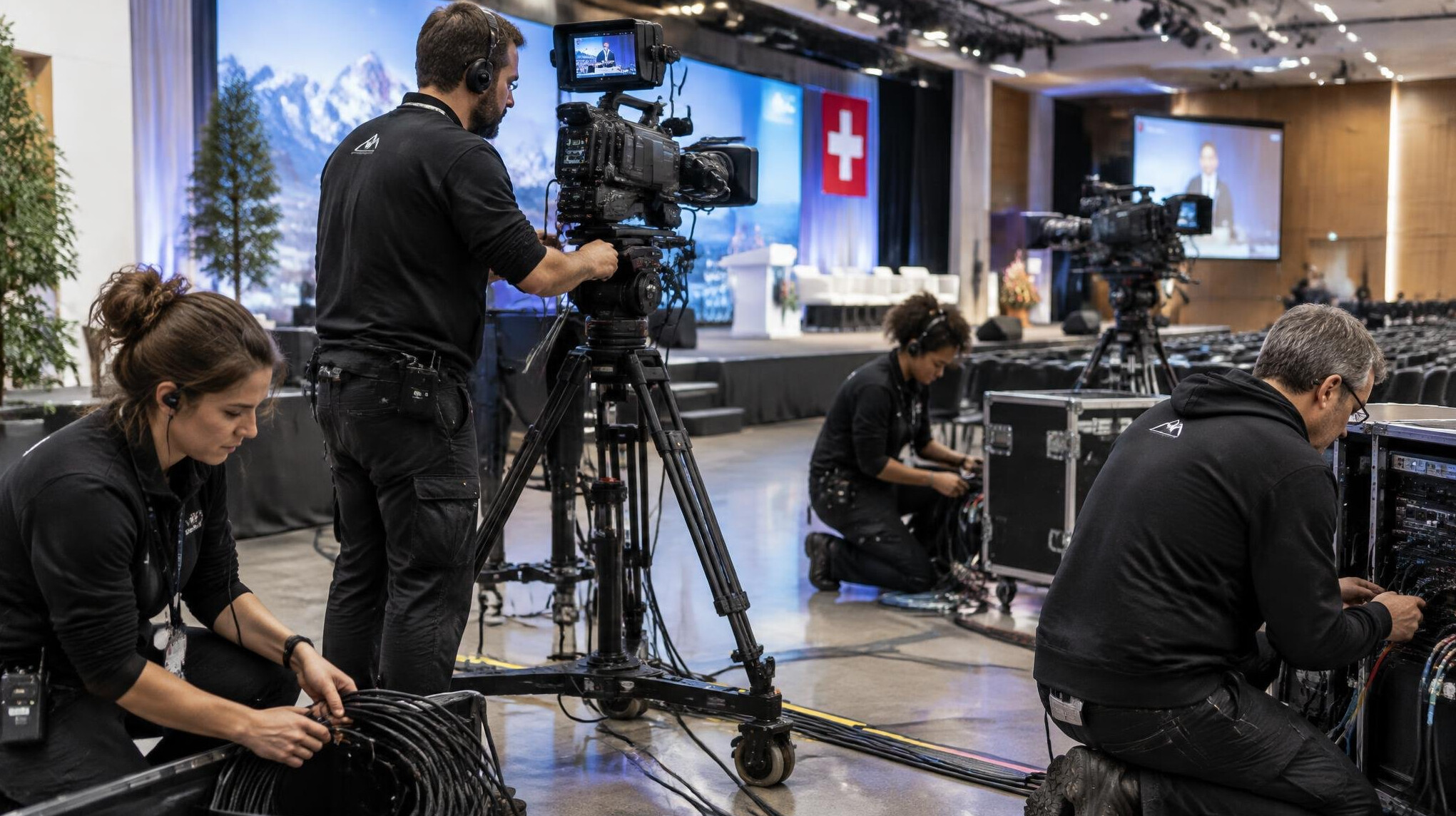 Corporate production crew setting up cameras for an on-site event broadcast